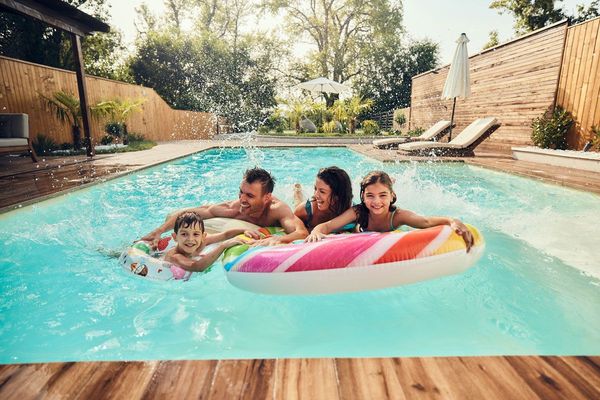 Family Having Fun During Summer Day in the Pool — Chula Vista, CA — Craftsman Swimming Pools and Landscaping