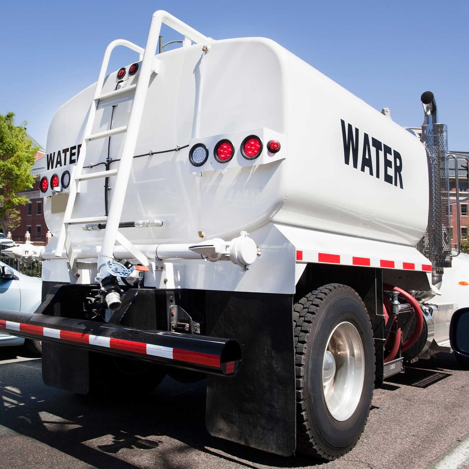 Rear and side view of parked water tanker truck