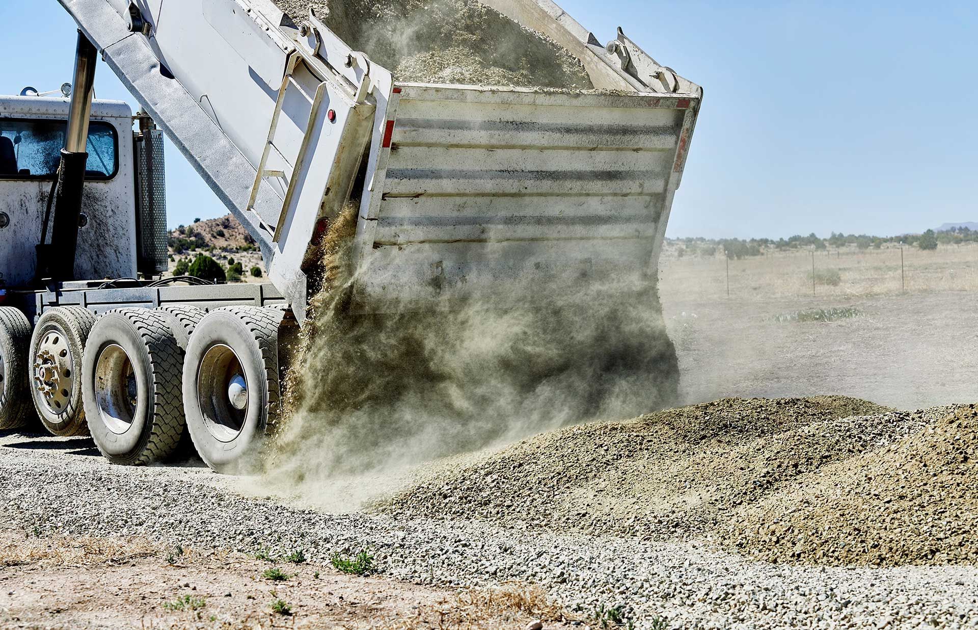 Dump Truck spreading Gravel on Driveway 
