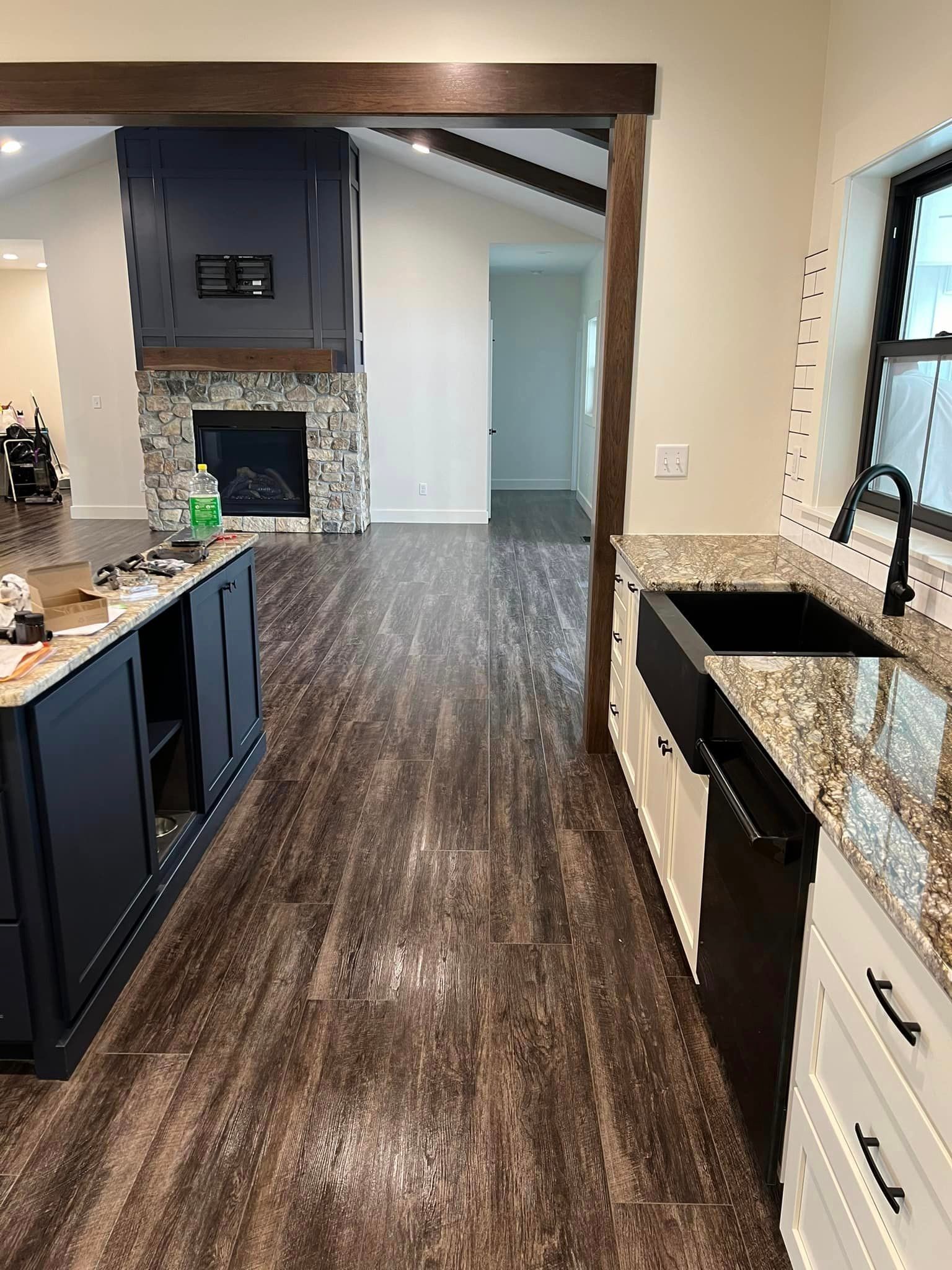 A kitchen with a sink , cabinets , and a fireplace.