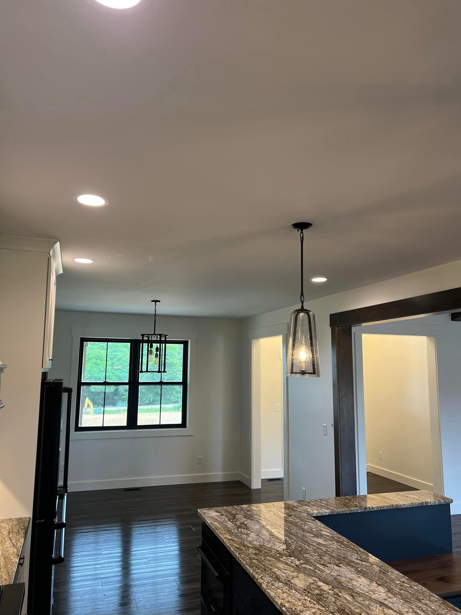 A kitchen with granite counter tops and a ceiling fan.