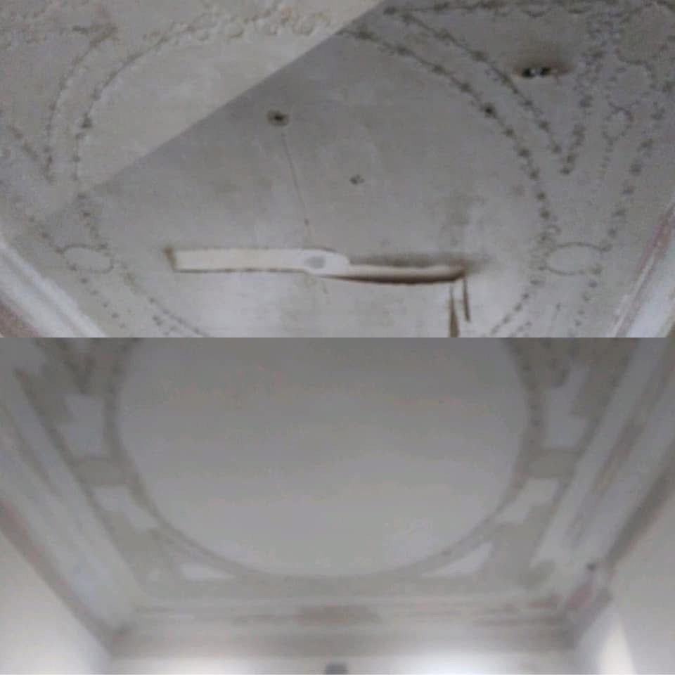 Two sections of a white ceiling with recessed geometric designs and a ceiling fan.