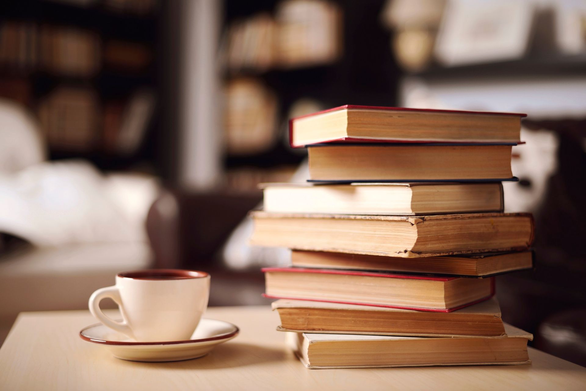 A stack of books with a coffee cup printed by Miro Printing & Graphics Inc.’s book printing services in North Bergen, NJ