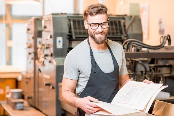 A man holding a book print and providing book printing services at Miro Printing & Graphics Inc. in North Bergen, NJ