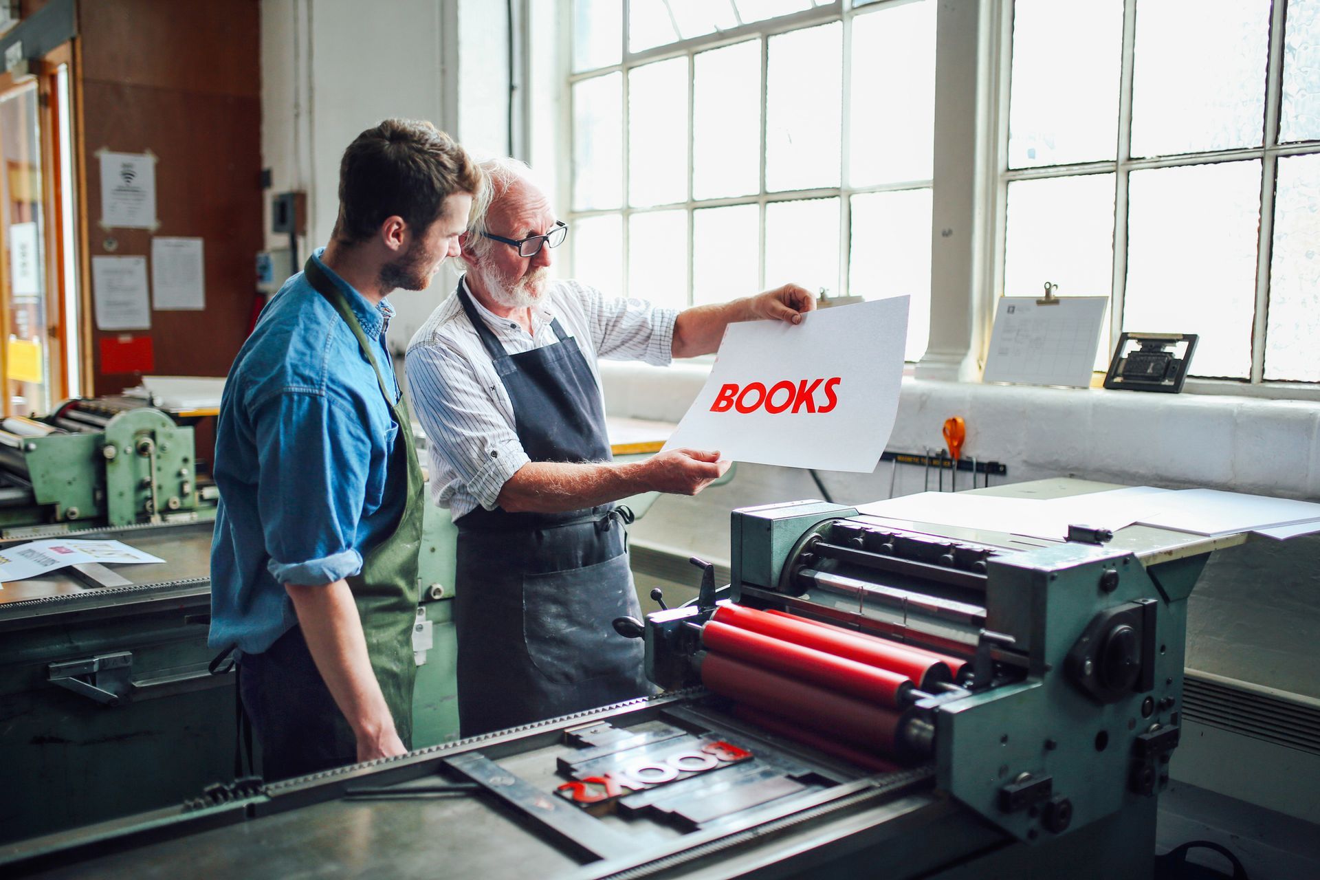 Senior technician showing letterpress print in book arts - Book Printing Services In North Bergen, Nj Senior technician showing letterpress print in book arts - Book Printing Services In North Bergen, Nj
