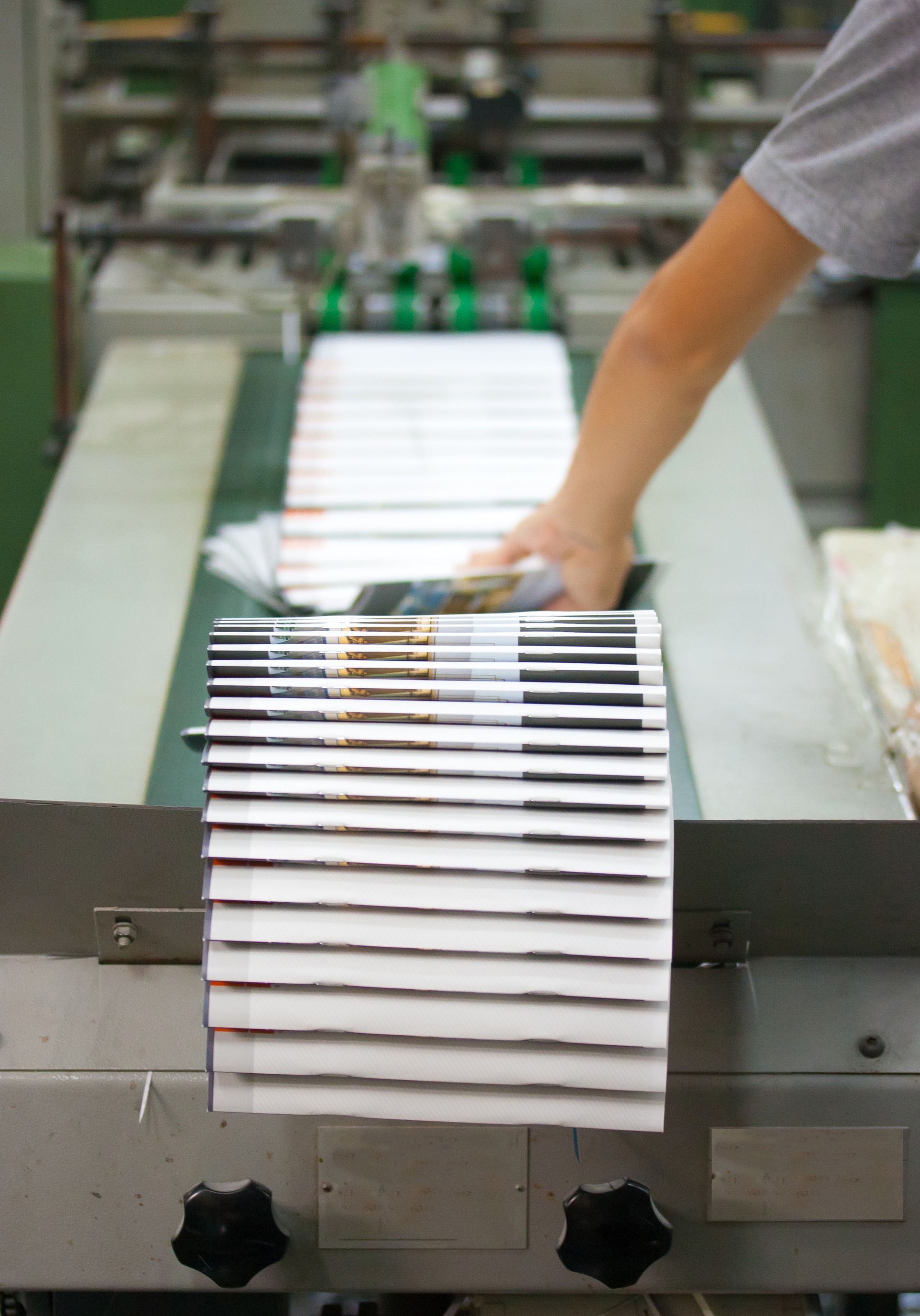 At Miro Printing & Graphics, Inc. in Hackensack, NJ, an individual works on a machine creating paper