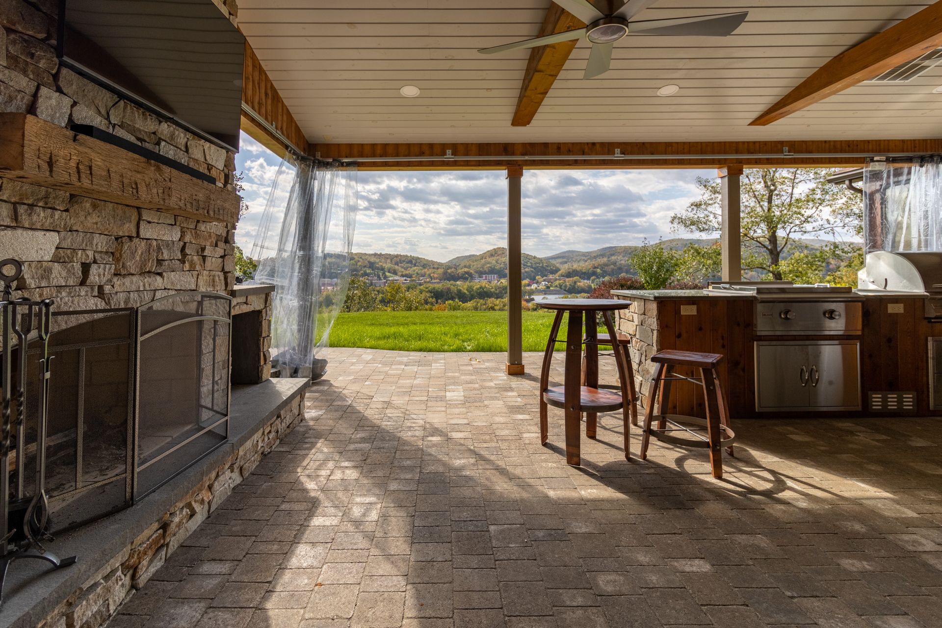 There is a fireplace in the middle of the room and a ceiling fan.