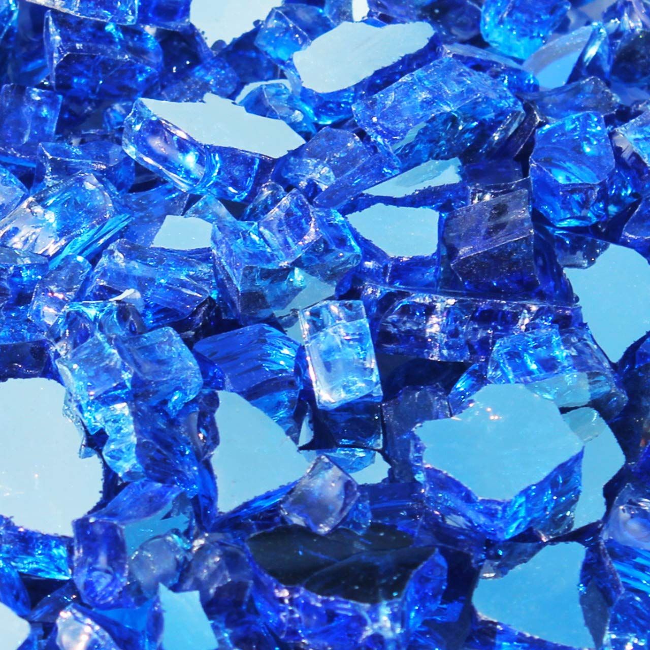A pile of blue glass pieces on a blue surface