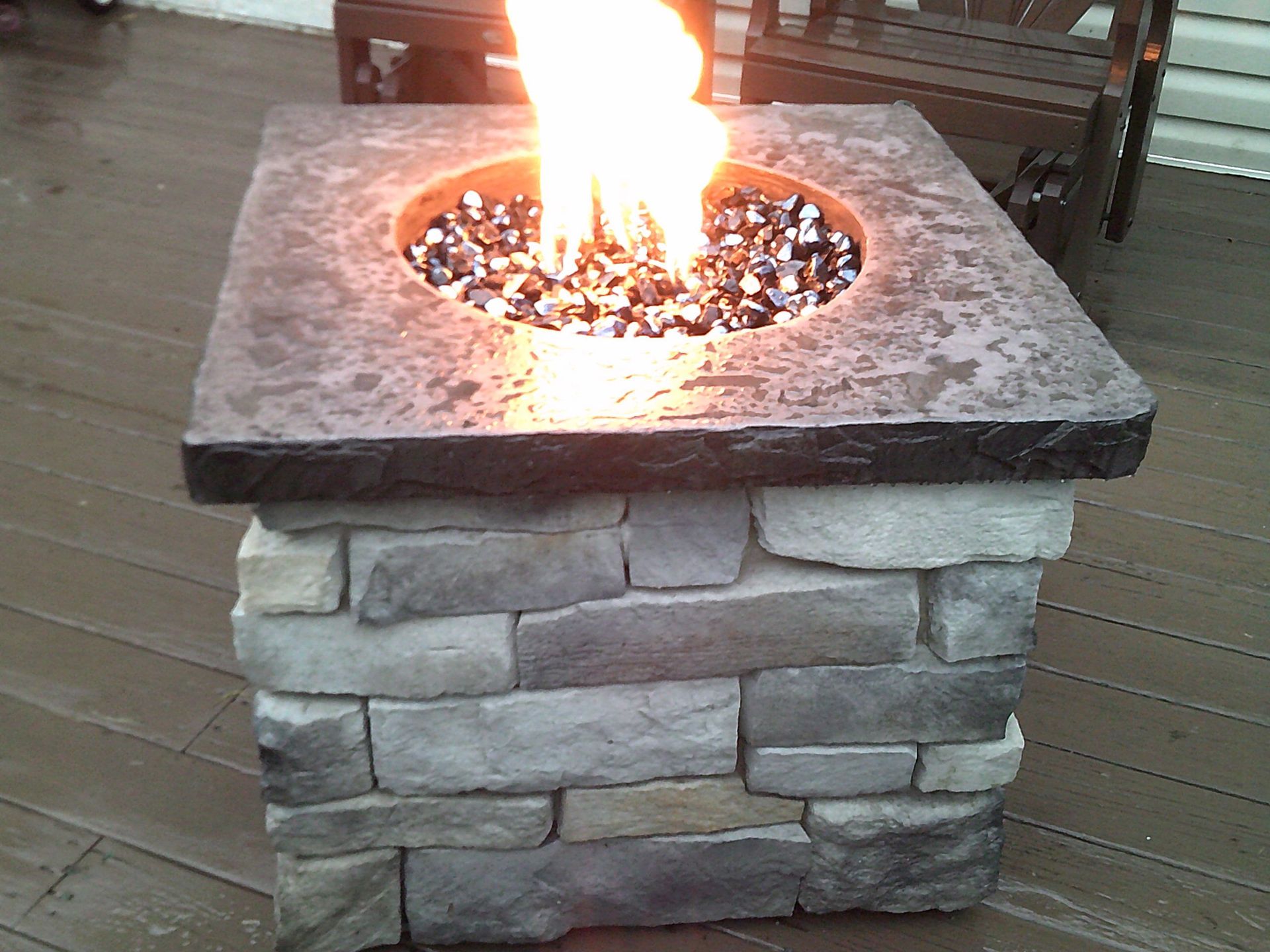 A fire pit with a fire coming out of it