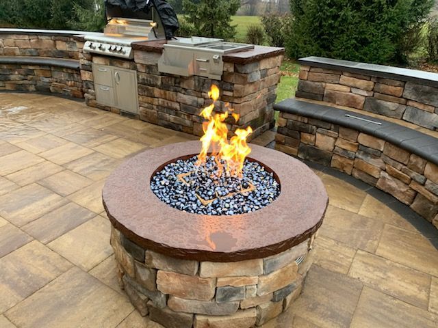 There is a fire pit in the middle of the patio.