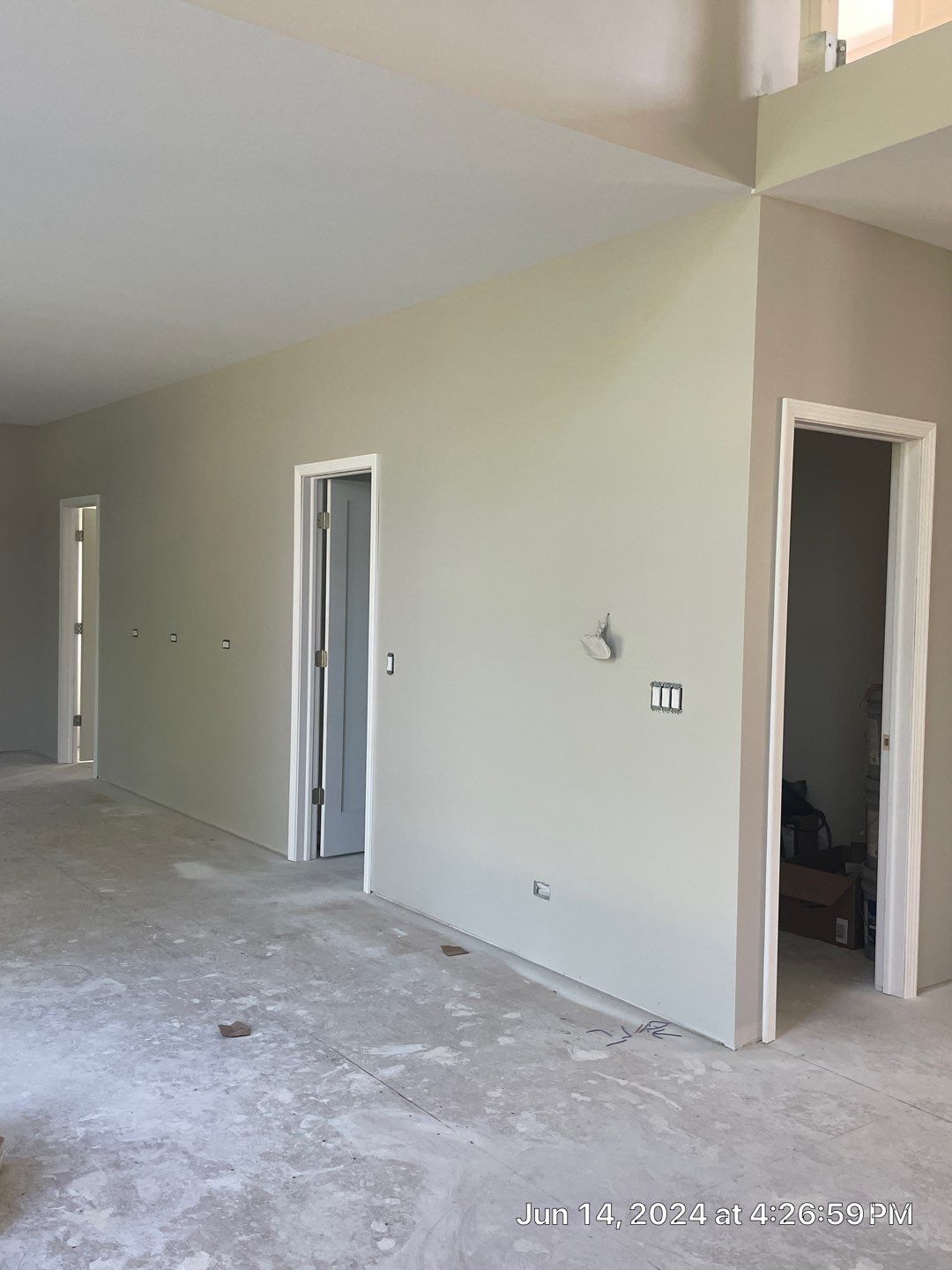 A large empty room with a lot of doors and a ceiling.