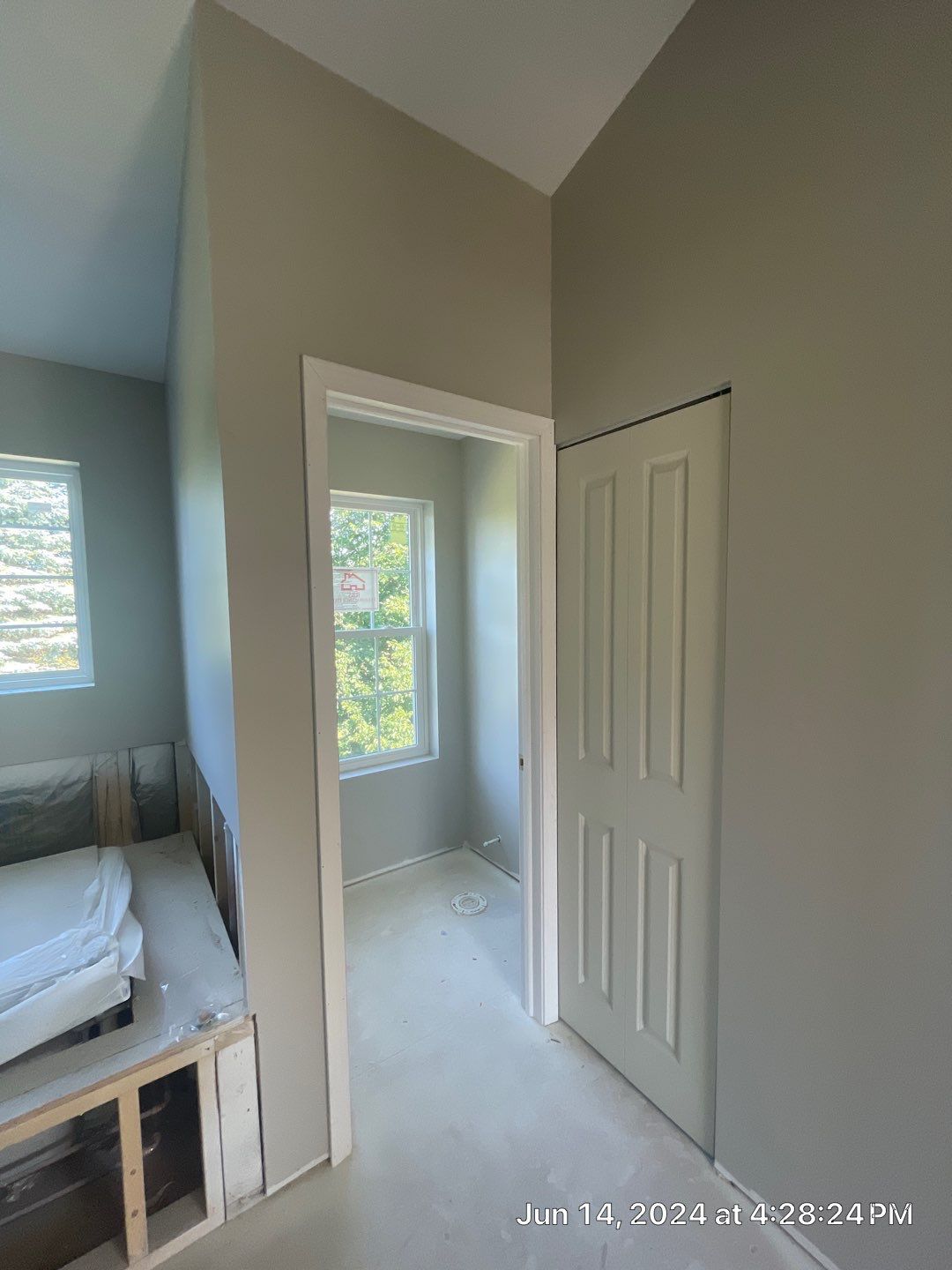 A bedroom with a closet and a window.