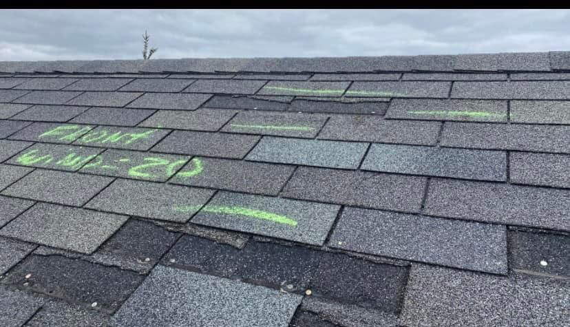 A close up of a roof with green markings on it.