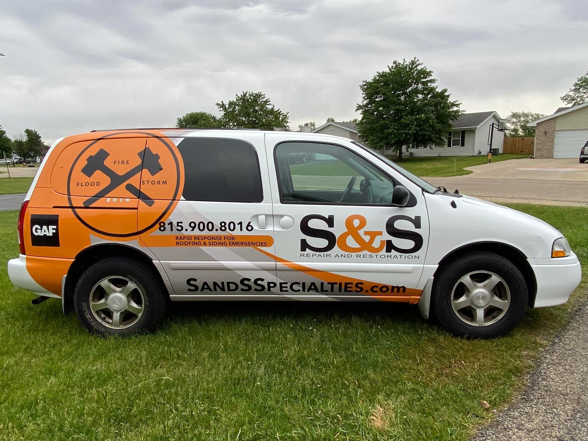 A white and orange van with s & s written on the side