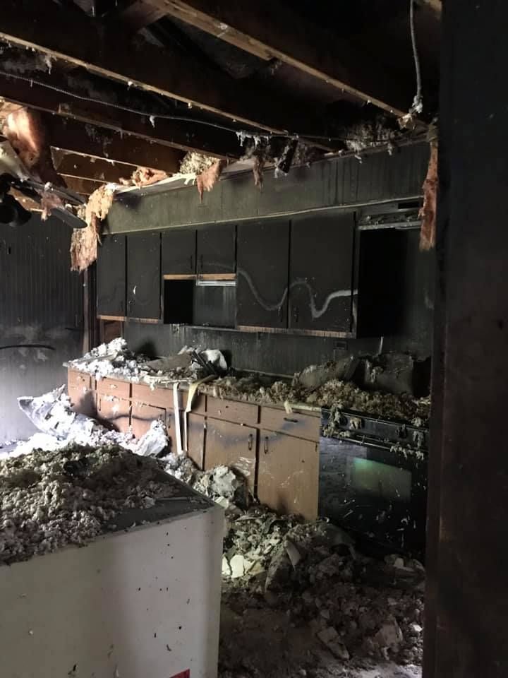 A kitchen in a house that has been damaged by a fire.