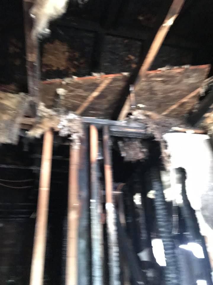 A bunch of pipes are hanging from the ceiling of a building