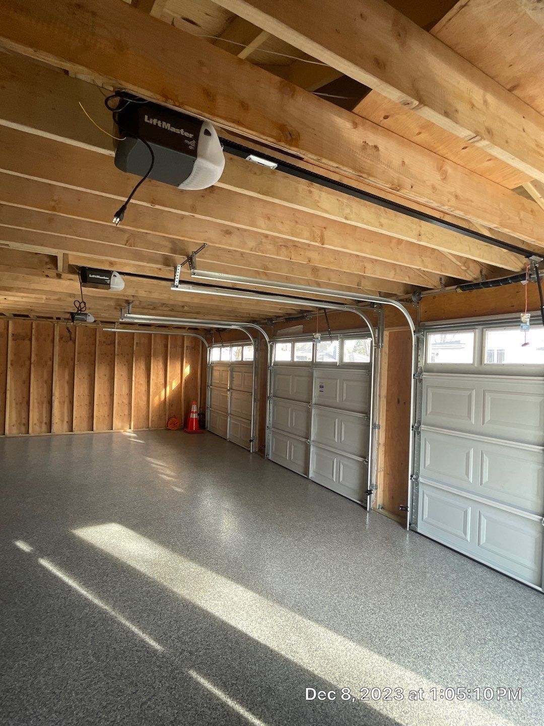 A garage with a lot of garage doors and a garage door opener.