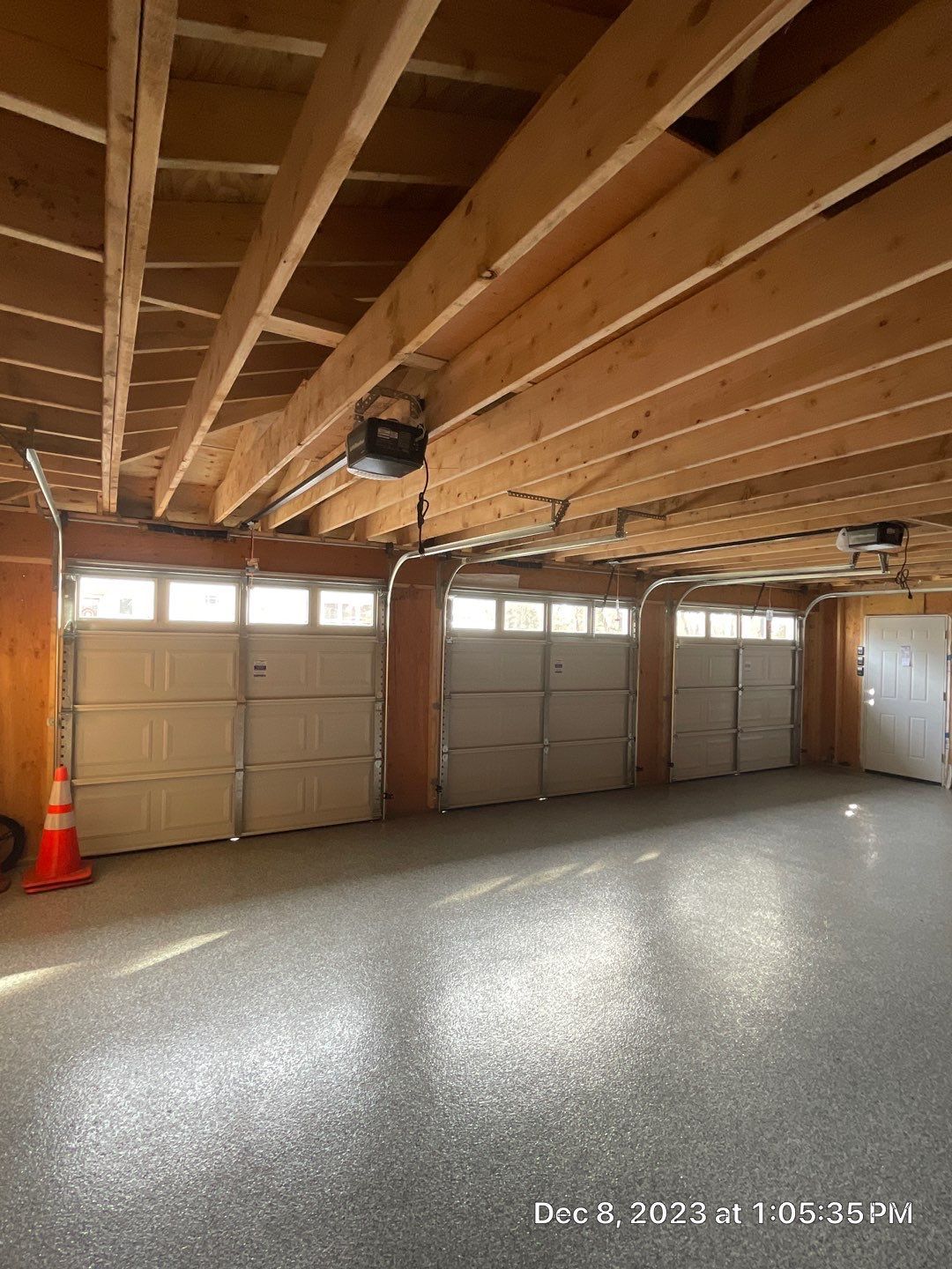 A garage with a lot of garage doors and a concrete floor.