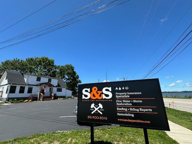A sign that says s & s in front of a house