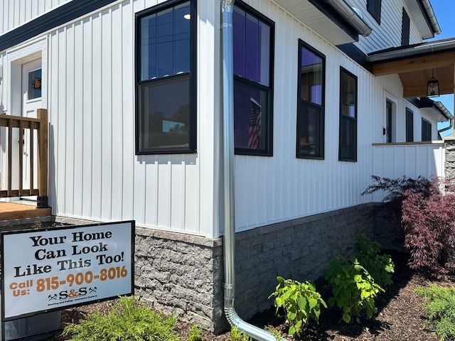 A white house with a sign that says your home can look like this too