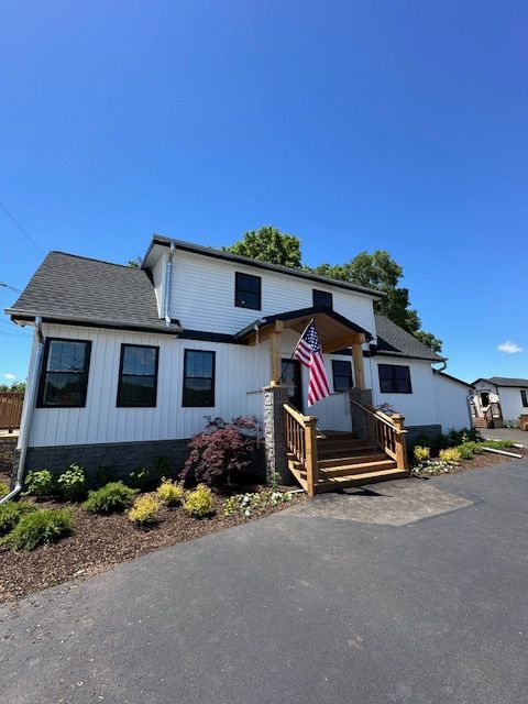 A white house with an american flag in front of it