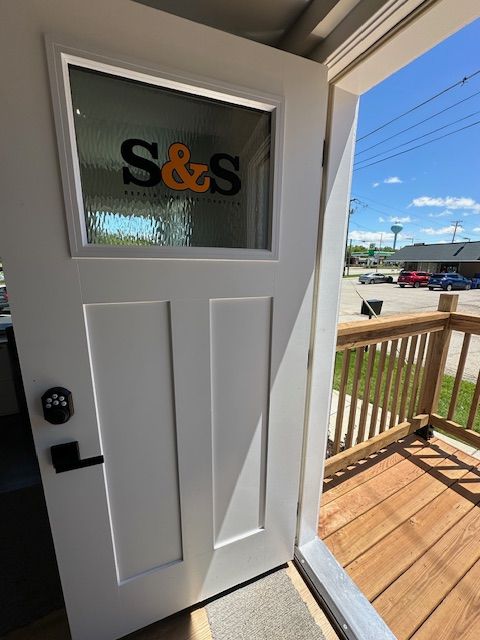 A white door with the word s & s on it