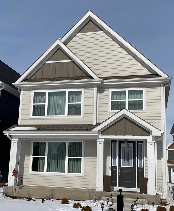 A house with a lot of windows and a black door