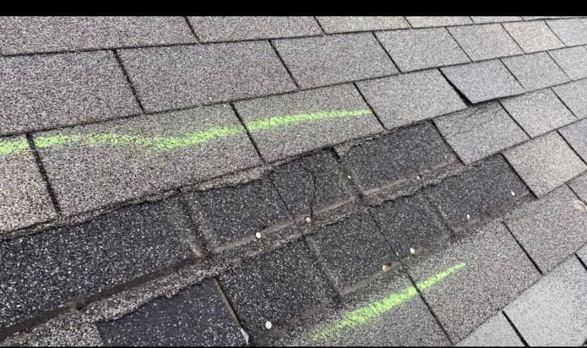 A close up of a roof with a green line on it.