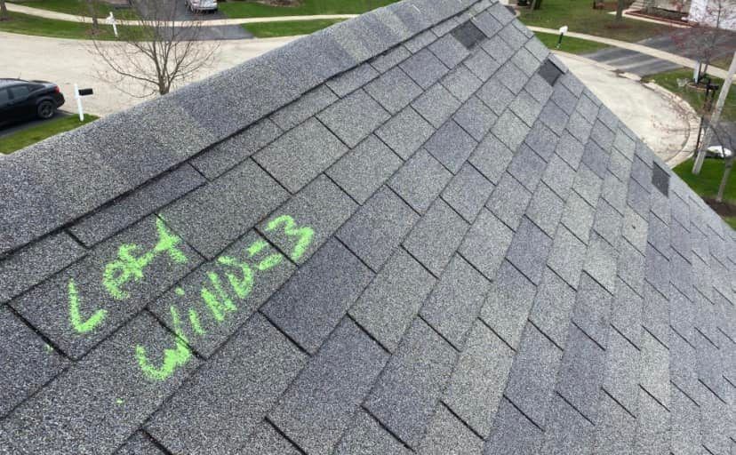 A close up of a roof with green chalk written on it.