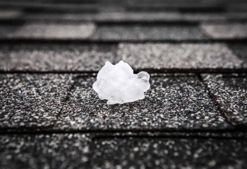 A piece of ice is sitting on top of a roof.