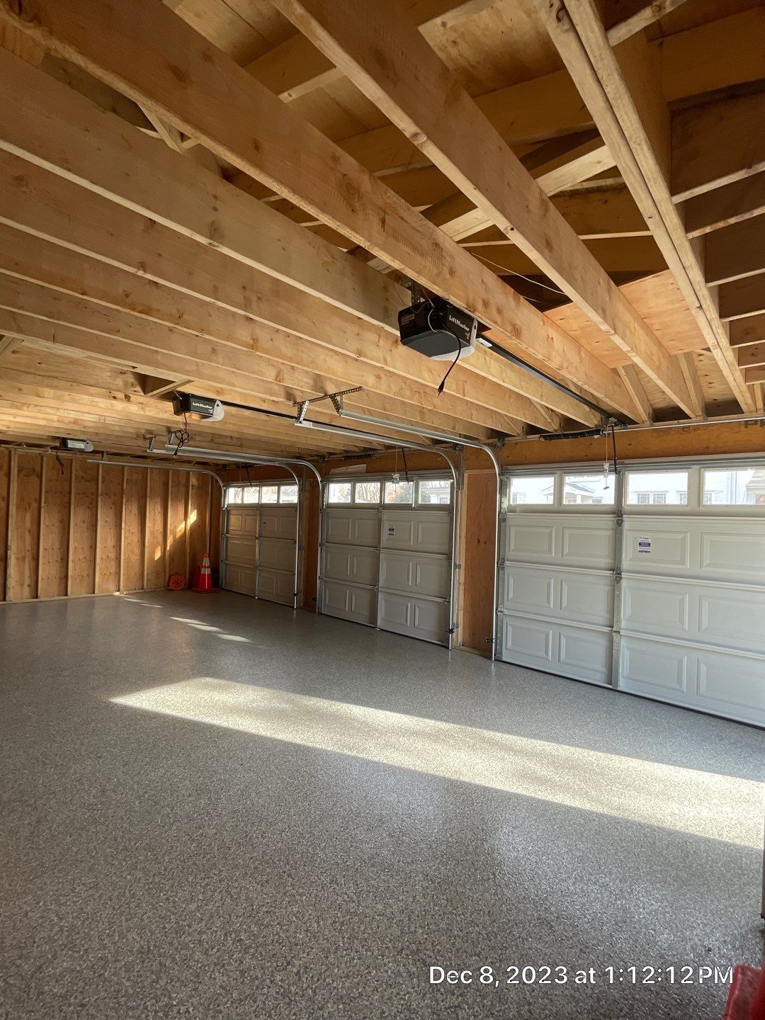 A garage under construction with a lot of garage doors.