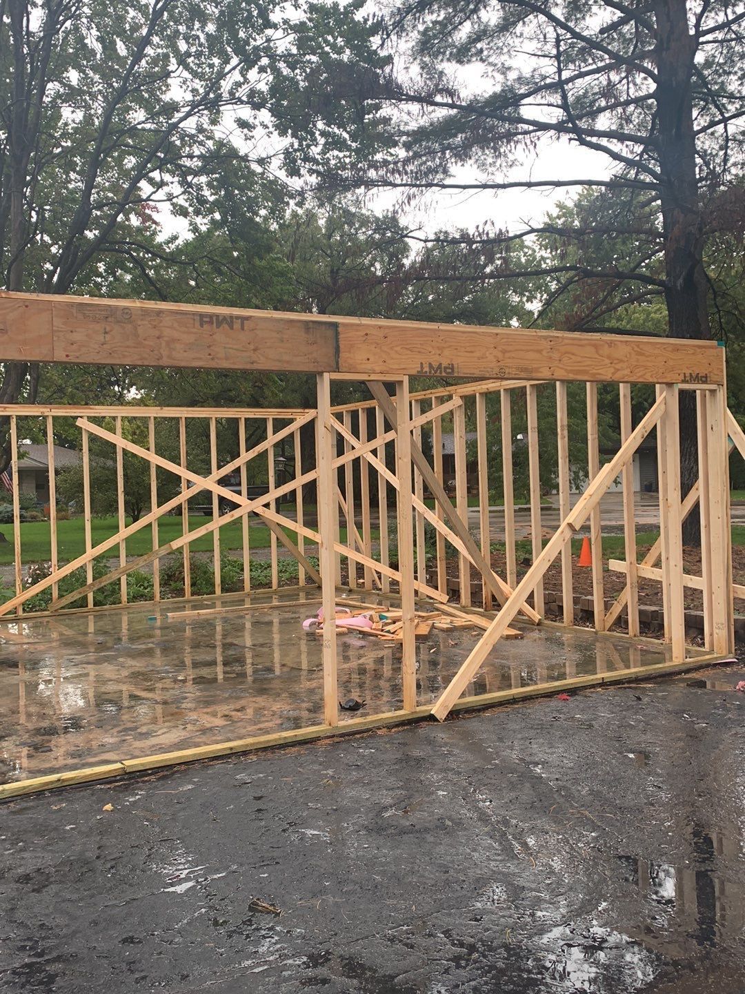 A wooden structure is being built on the side of the road.