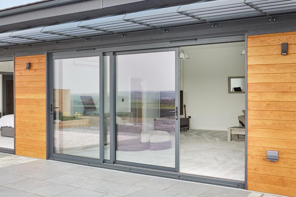 A large sliding glass door is open to a living room.