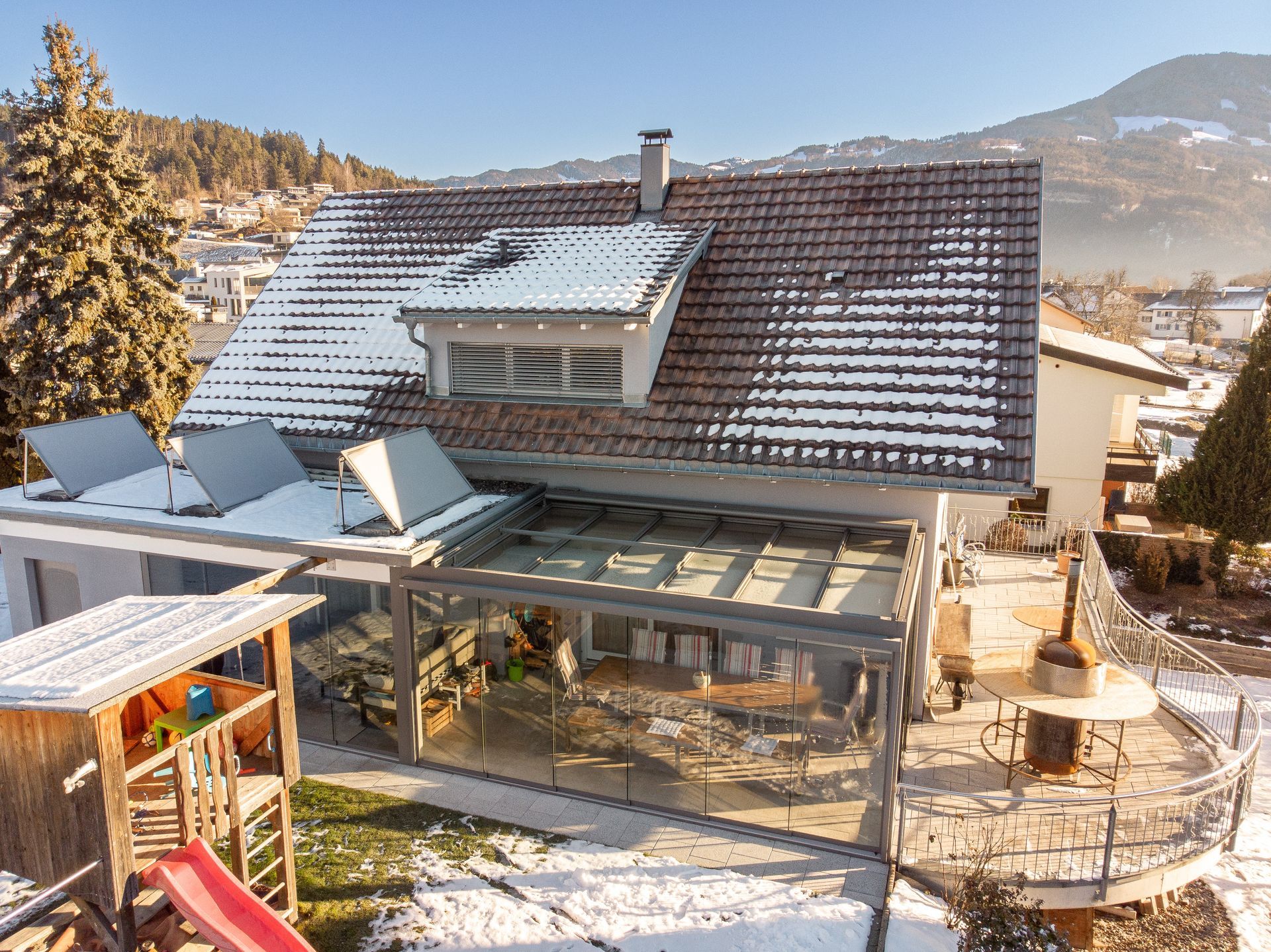 An aerial view of a house with a slide in the backyard.