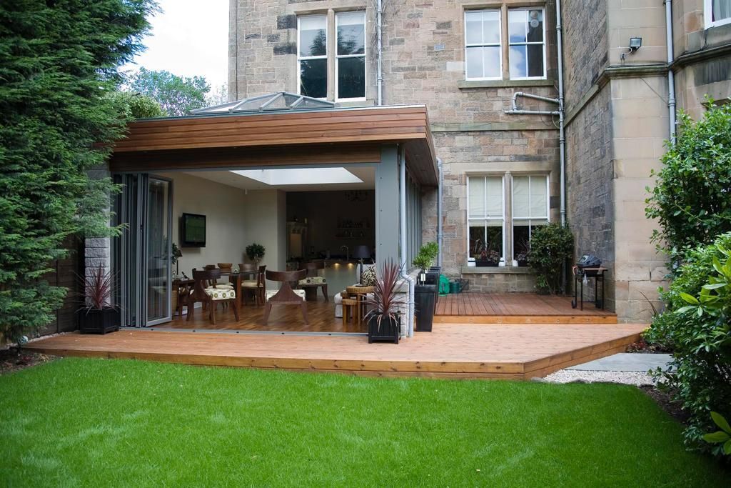 A large brick house with a wooden deck in front of it