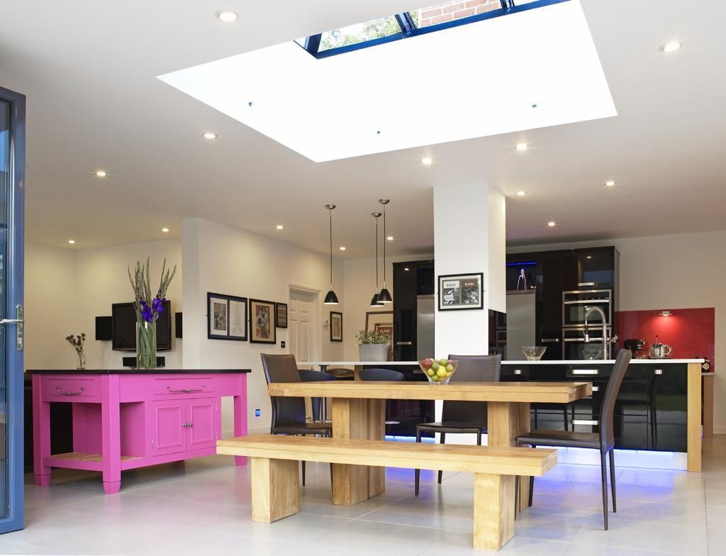 A dining room with a wooden table and benches