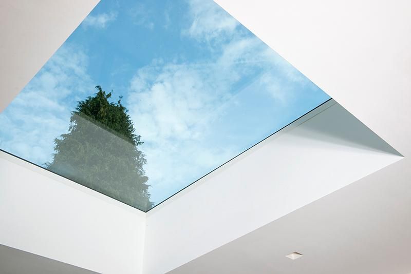 Looking up through a skylight into a blue sky