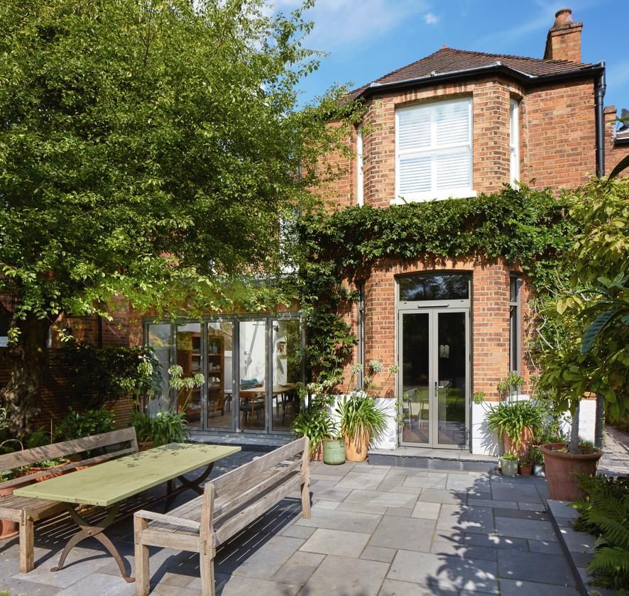 A brick house with a patio in front of it