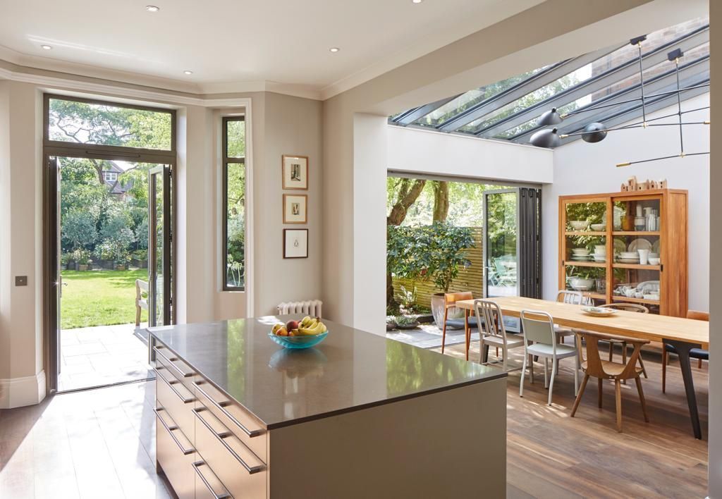 A kitchen and dining room with a large island in the middle of the room.