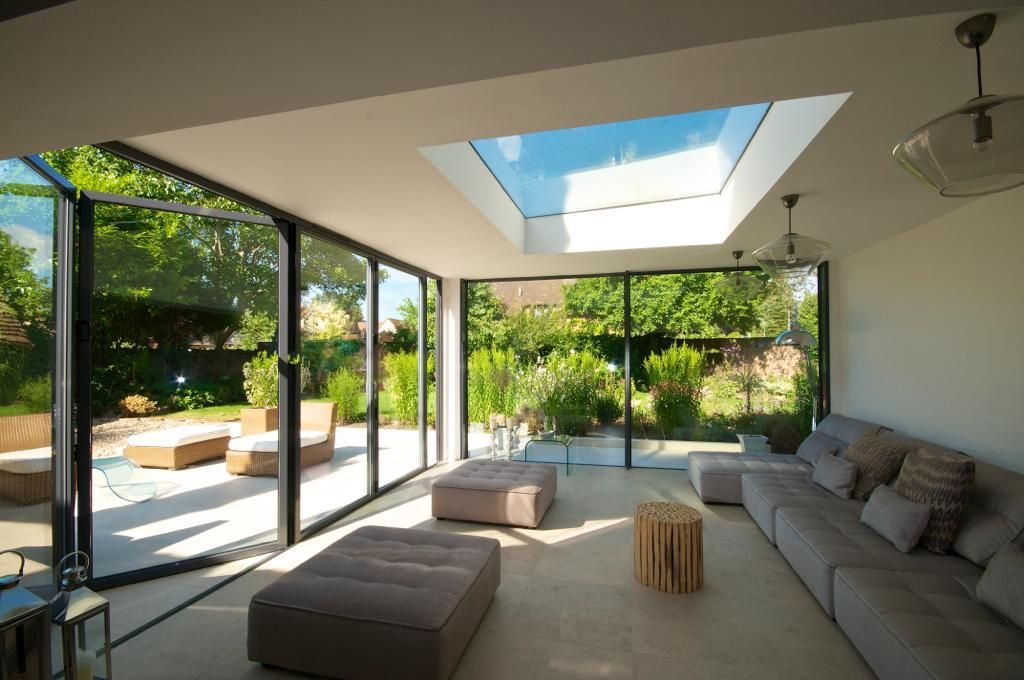 A living room with a lot of windows and a skylight