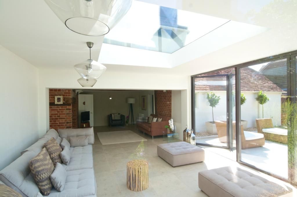 A living room with a couch and ottomans in it