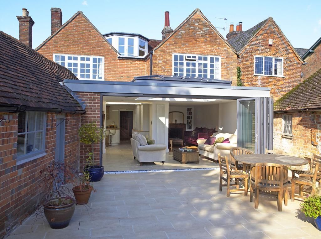 A brick house with a patio in front of it