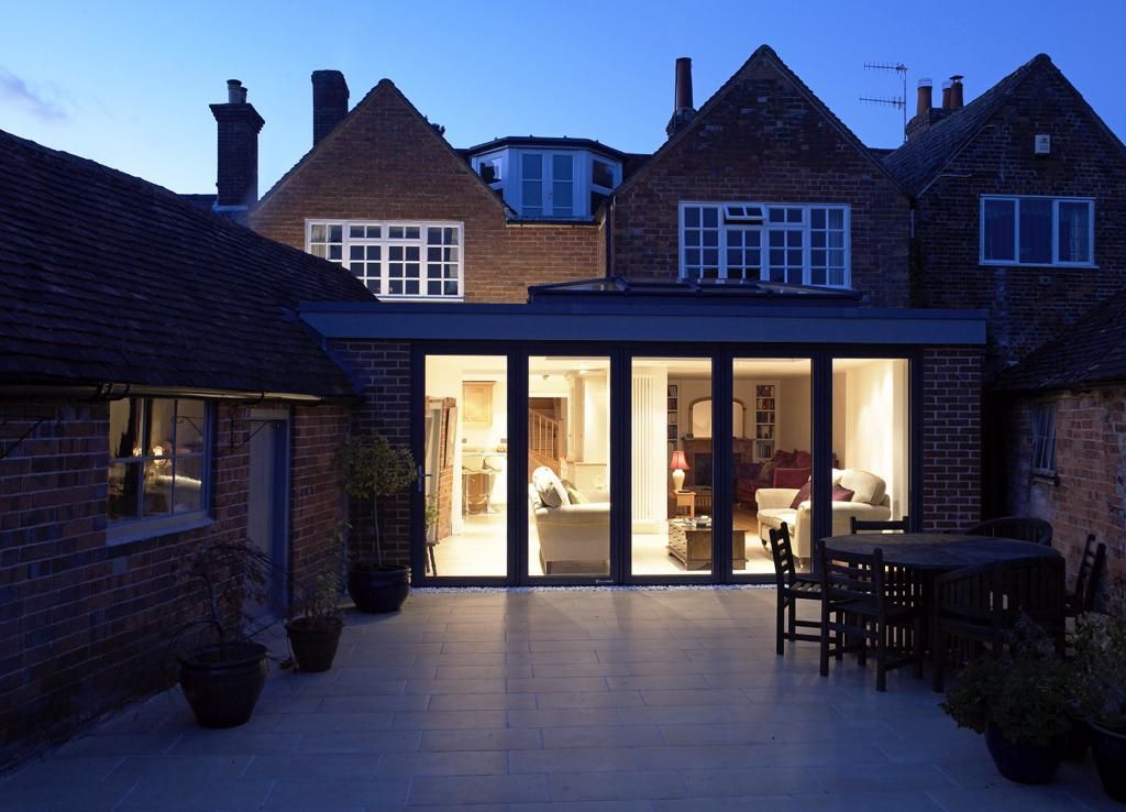 A house with a patio and a table and chairs in front of it