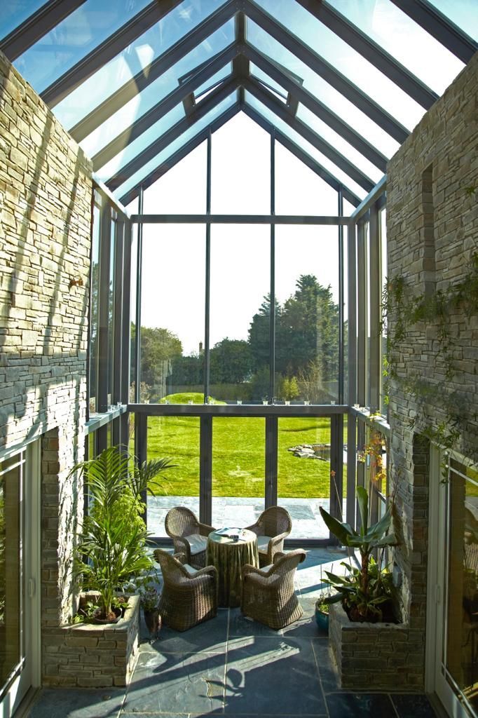 A room with a lot of windows and chairs in it