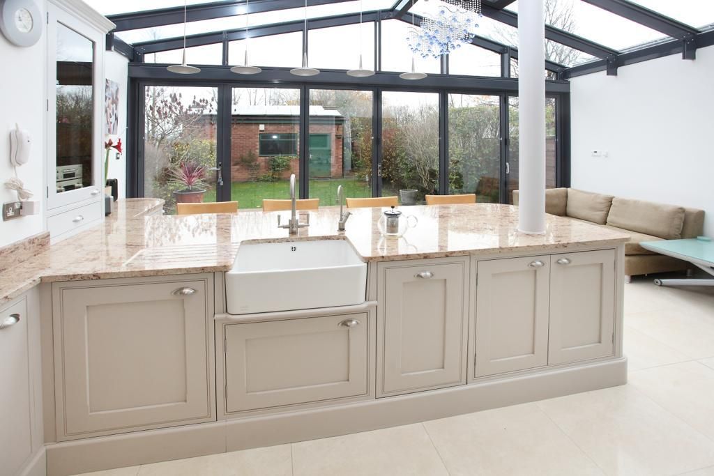 A kitchen with a large island and a sink.