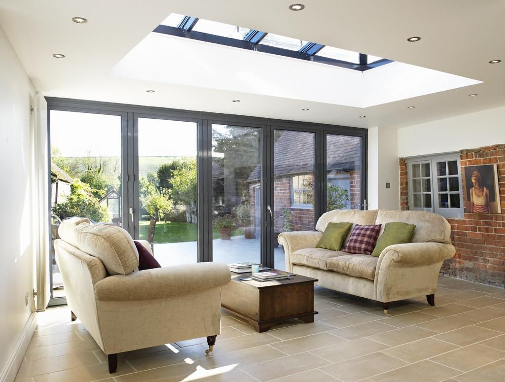 A living room with a couch , two chairs and a coffee table.
