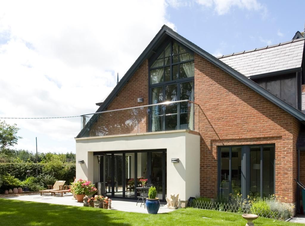A large brick house with a balcony and sliding glass doors