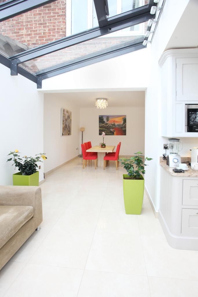 A living room leading to a dining room with a table and chairs