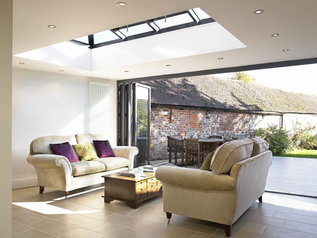 A living room with a couch and chairs and a table