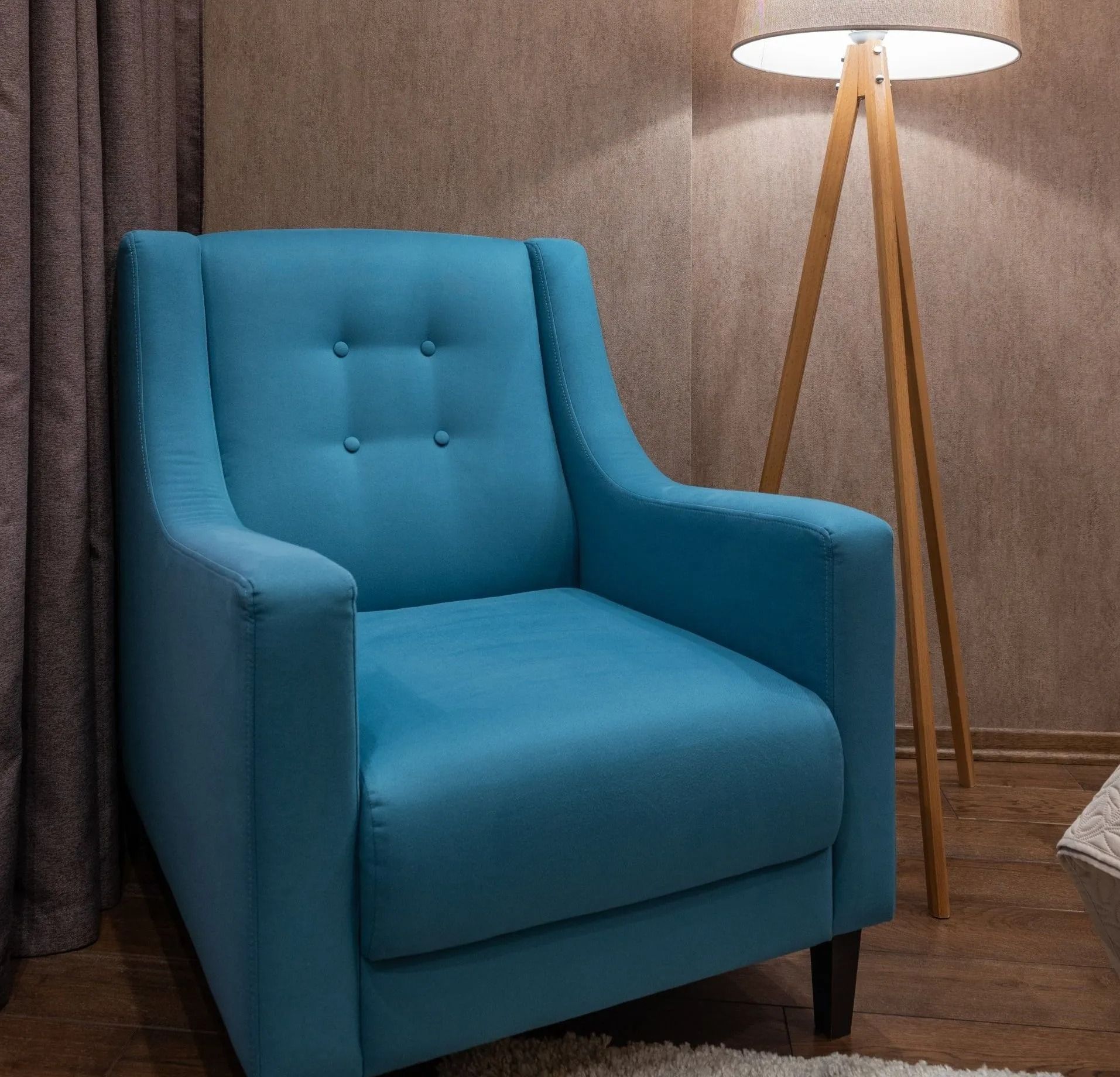A Blue Chair Is Next to A Lamp